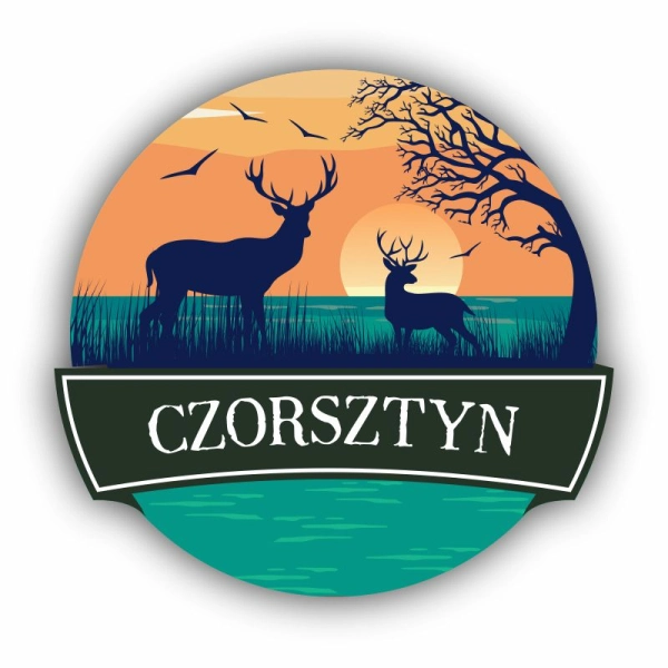 Okrągły magnes na lodówkę z grafiką jelenia na tle zachodzącego słońca.