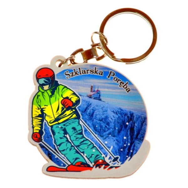 Breloczek w kształcie narciarza wpisanego w koło z widokiem.